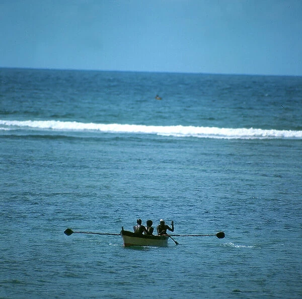 Mogadishu. 'URI', Somalian fishing boats breaking over the wave of the coral reef, for the open sea