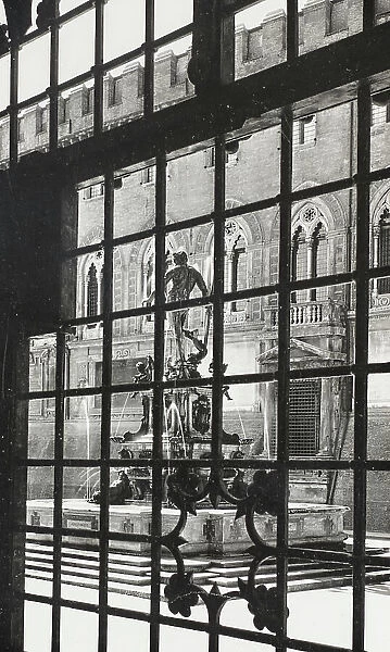 The Neptune fountain seen through a gate, Bologna