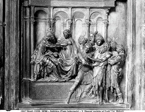 Panel representing St. John the Baptist led by Herod. Sculpted work by Lorenzo Ghiberti, belonging to the Baptismal Font of the Baptistery of Siena