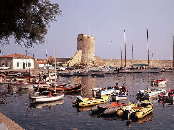 The port of Marciana Marina on the island of Elba with boats at anchor. Along the pier the cylindrical Medici or saracen tower