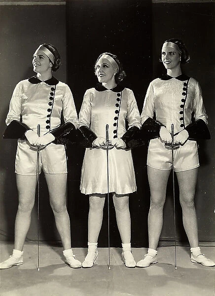 Portrait of three female gymnasts in fencing clothes