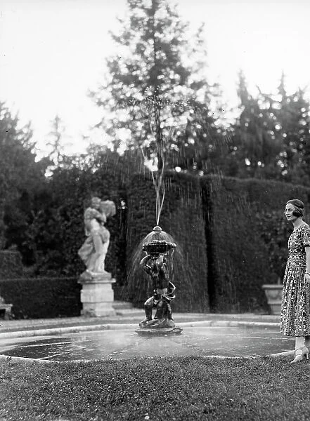 Portrait of a woman near a fountain in the garden of Villa Don delle Rose