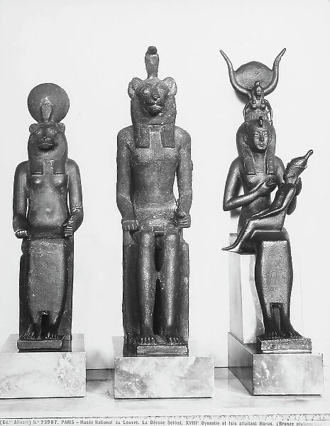 Three Ptolemaic age bronze statuettes depicting the Goddesses Sekhmet and Isis in the act of breastfeeding the young Horus; the works are preserved in the Louvre Museum, Paris