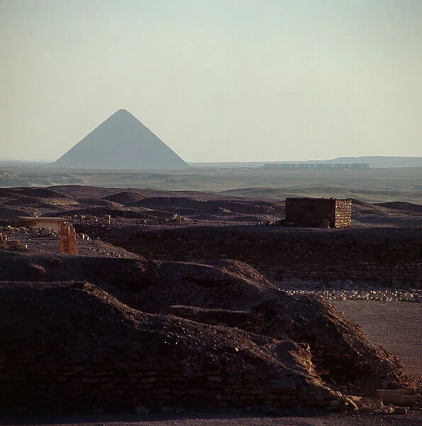 The pyramids of Giza in the distance, even against the sunset