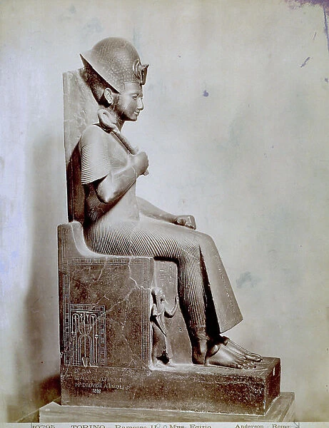 Statue of the pharaoh Ramses II seated on a throne. The statue comes from Thebes and is in the Egyptian Museum in Turin