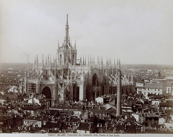 View from above of the bell tower of the Church of San Carlo in Milan. At the center of the picture the Cathedral and the roofs of the surrounding houses