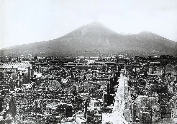 View of the Vicolo di Modesto amidst the ruins of Pompei. The Vesuvius stands out in the background