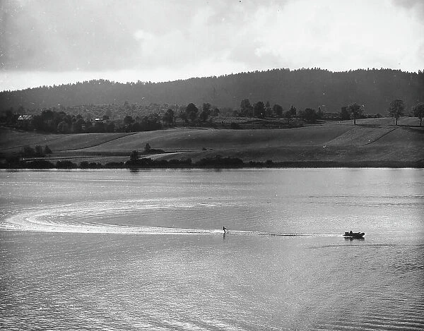 Waterskiing on a lake surrounded by hills