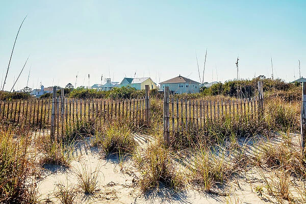 Georgia, Tybee Island, waterfront homes wooden fence and sand dunes