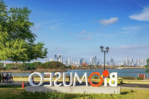Panama, Panama City, Amador Causeway, Biomuseo sign with view of city skyline in the background