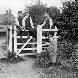 Boys sitting on gate a97_05319