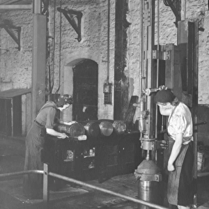 Women war workers stamping ammunition shells in B Shop, 1942
