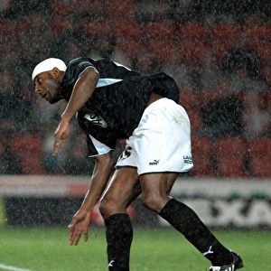 Dele Adebola challenges for the ball in the
