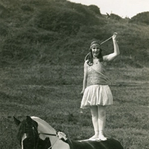Acrobat of Sangers Circus standing on a horse