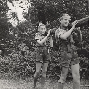 Two Austrian boy scouts lifting a pole