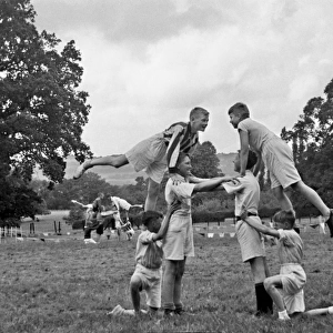 Boys doing acrobatics in a field