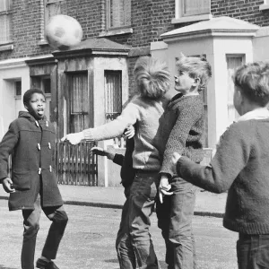 Boys playing football in a street, Balham, SW London