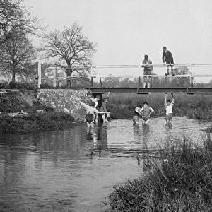 Boys in a stream and on a bridge