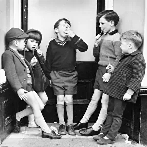 Children with ice lollies on a Balham street, SW London