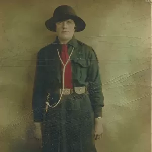 Colour photograph of a girl guide in uniform. Date: c. 1930