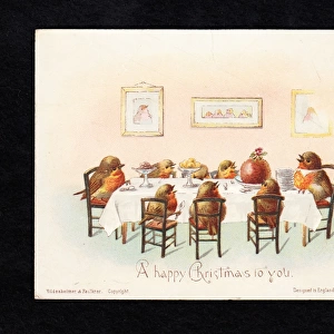 Family of robins at a table on a Christmas card