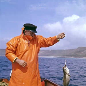 Fisherman with pollock, Lands End, Cornwall