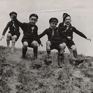 French cub scouts sliding down a slope