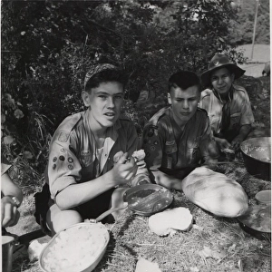 French scouts eating from earth table