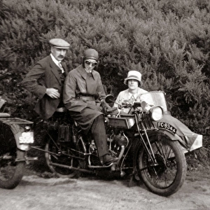 Gentlemen & lady on vintage motorcycle combination at roadsi
