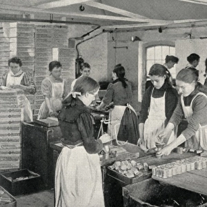 Girls filling penny tins of mustard, Norwich, Norfolk