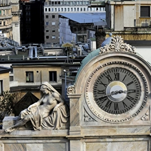 Italy. Milan. Clock decorated with two statues