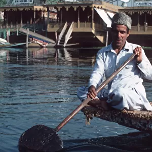 Lake Dal, Srinagar, Kashmir - a man paddling boat