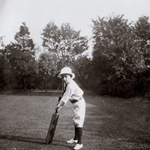 Little boy practising cricket in garden, Ealing, West London