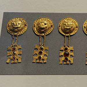 Metal Age. Gold ornaments with lions head. Womans grave fr