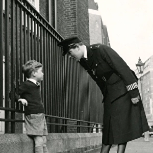 Metropolitan Police officer speaking to a little boy