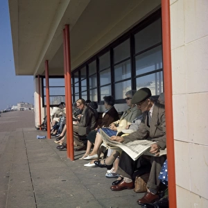 Middle-aged people in a beach shelter at the seaside
