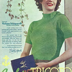 Model wearing tight crocheted cotton sweater in green with a tie collar, the cotton endorsed by couturier Mme Schiaparelli Date: 1935