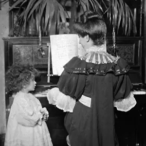 Mother and child in the parlour at the piano
