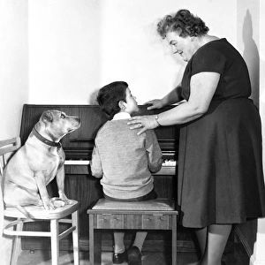 Mrs Mills, celebrity pianist, with boy and dog