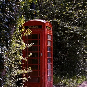 Old style telephone box in a quiet country village road
