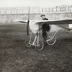 Pilot Sitting on Bi-Cycle Aircraft with Adverts in the ?