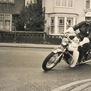 Policeman riding a Triumph motorcyle
