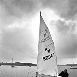 A sailor prepares his small yacht for a sail on Rutland Wate