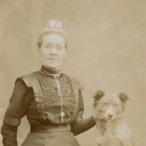 Studio portrait, middle aged woman with terrier