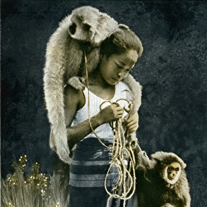 Thai woman accompanied by two gibbons