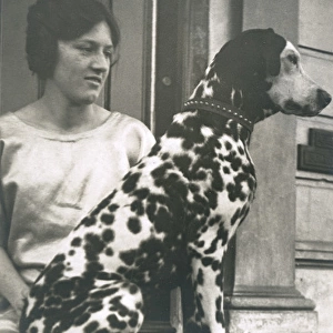 Woman with Dalmatian outside a house