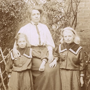 Woman with her two daughters and a Scottish Terrier