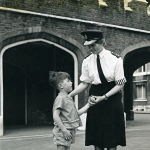 Woman police officer with little boy, London