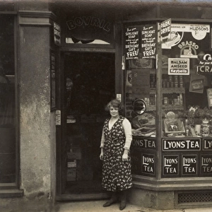Woman standing outside a grocers shop