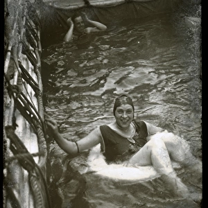 Woman swimming with a lifebelt in a pool